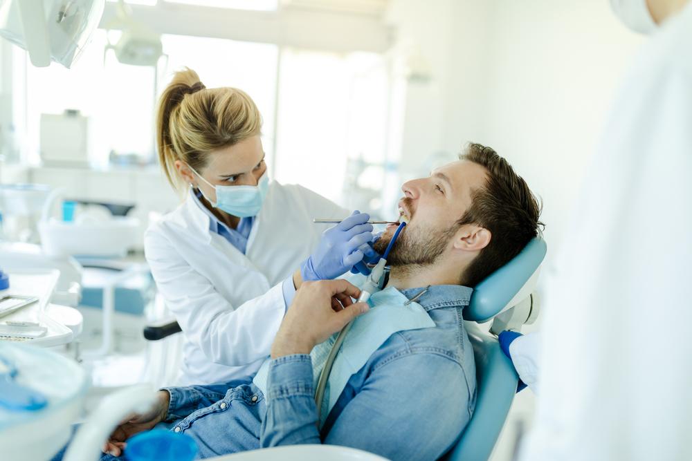 Young,Man,Visit,Dentistry,Clinic,For,Professional,Teeth,Treatment.,Doctor